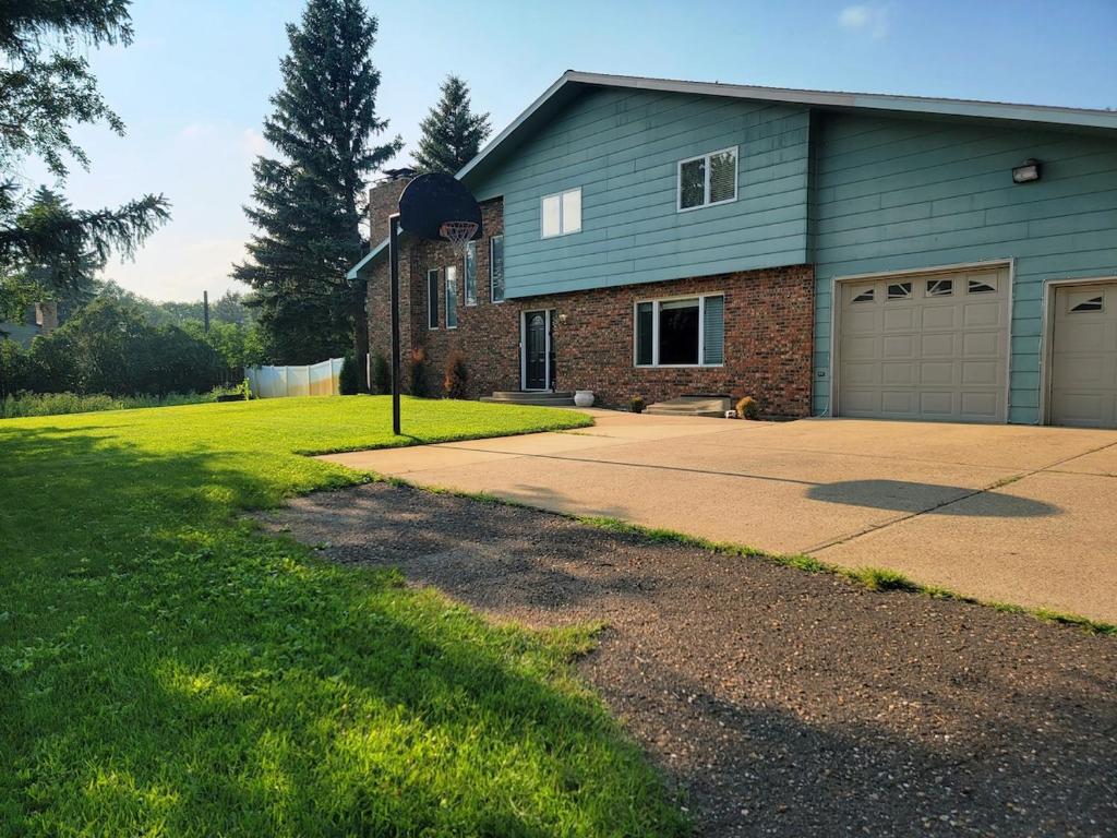 a house with a garage and a driveway at Dakota Lodge in Dickinson