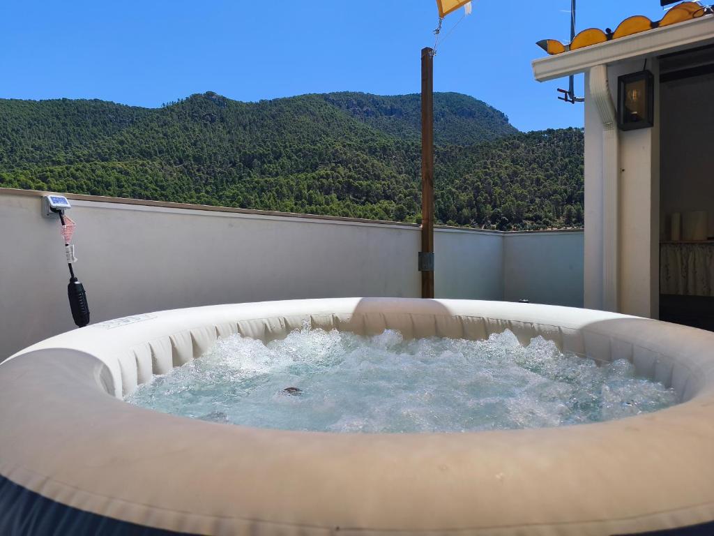 a jacuzzi tub on the balcony of a house at Alojamiento Rural El Lentisco in Puente Honda
