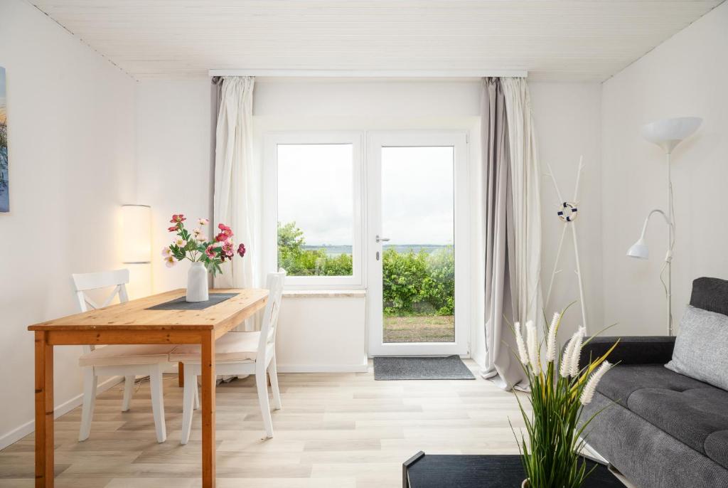 a living room with a table and a couch at Fördeperle Laboe in Laboe