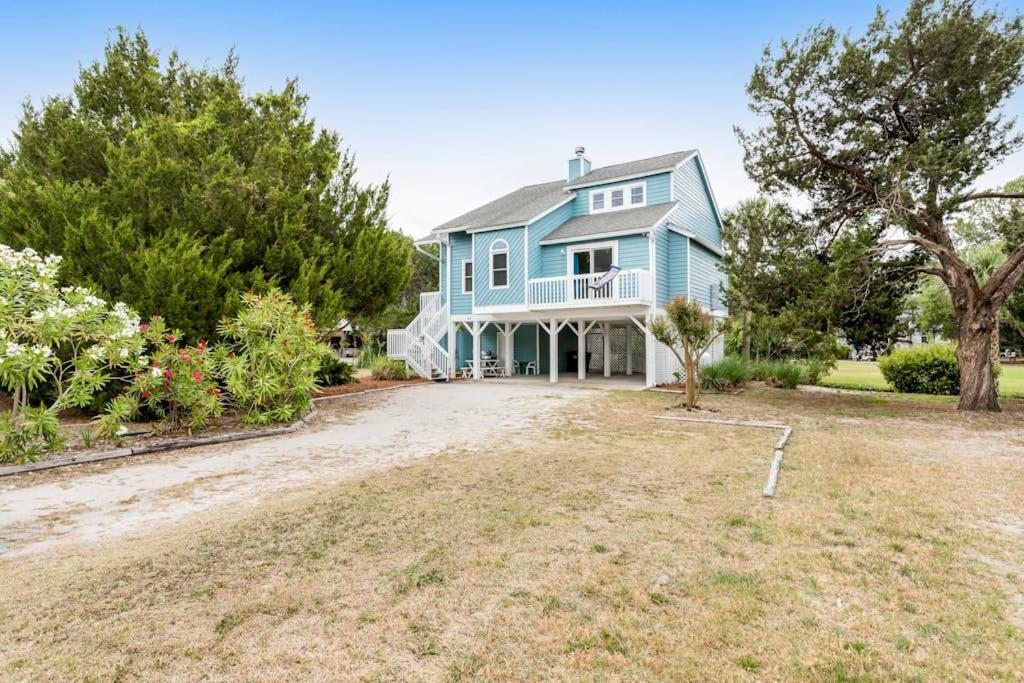 a large blue house with a large yard at Heh Edisto in Edisto Beach