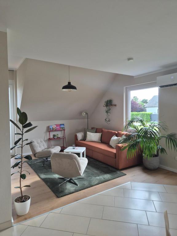 a living room with a red couch and a rug at Rebenmeer Wohnung in Roschbach in Roschbach