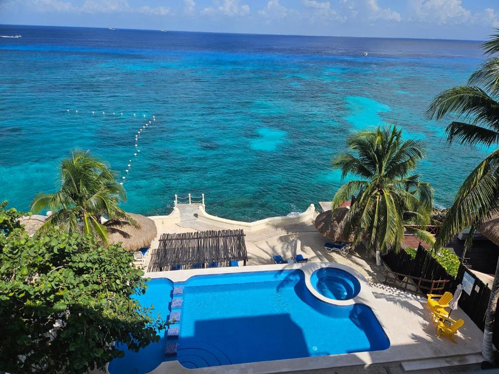 a view of the ocean from a resort with a swimming pool at Cantamar 401, huge condo , incredible views, Sargassum Free in Cozumel