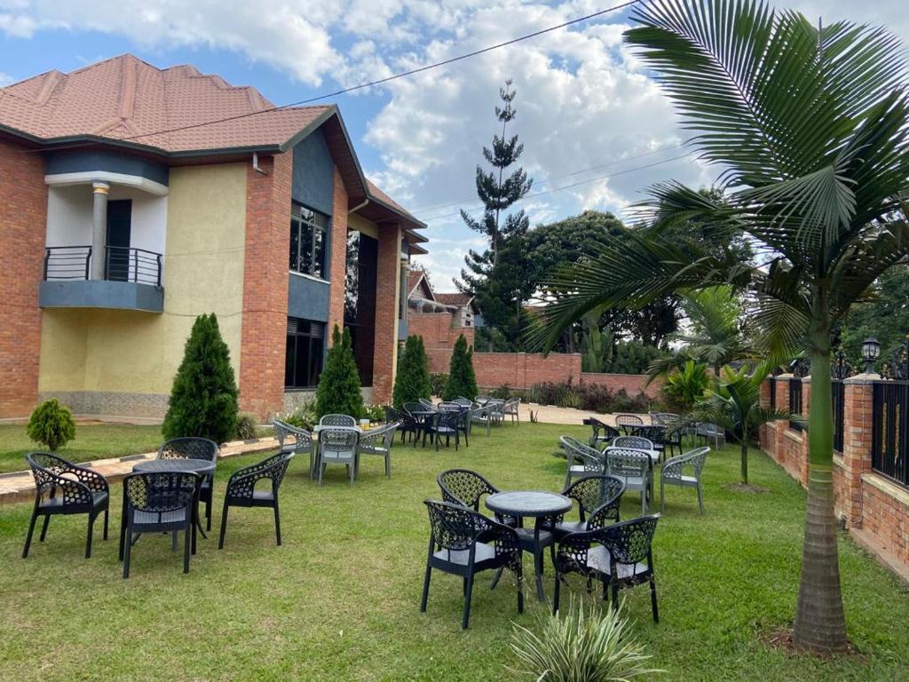 a group of tables and chairs in front of a building at Khartoum Nights in Kigali
