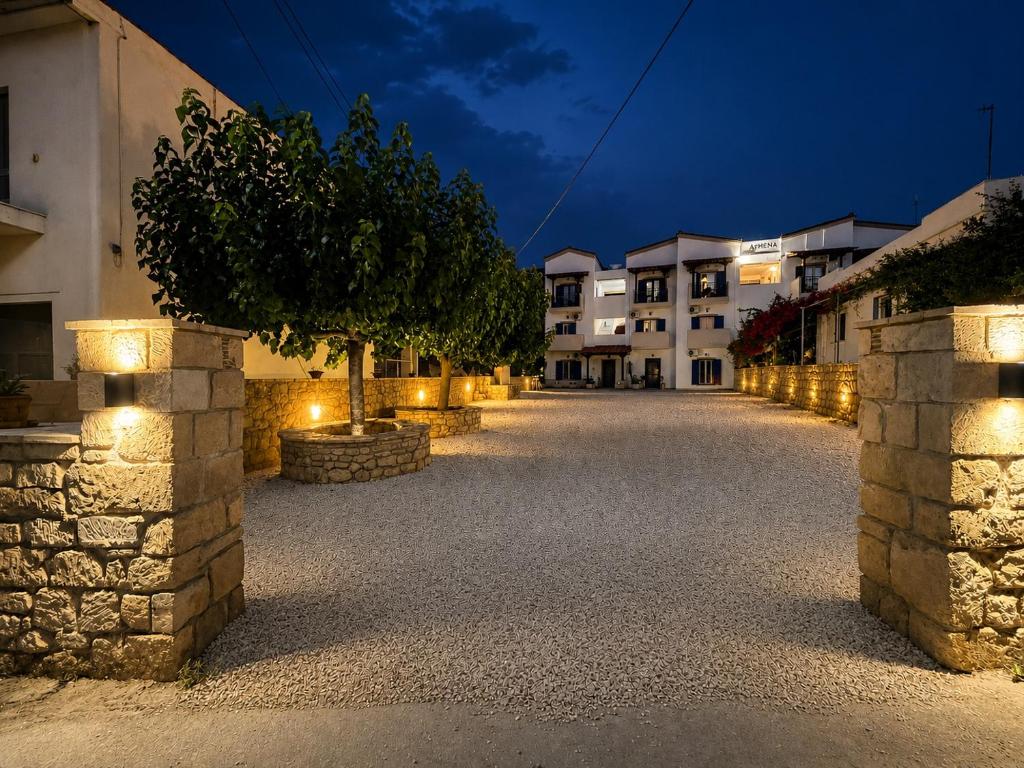 a street in a town at night with lights at STUDIOS ATHENA in Megalochori
