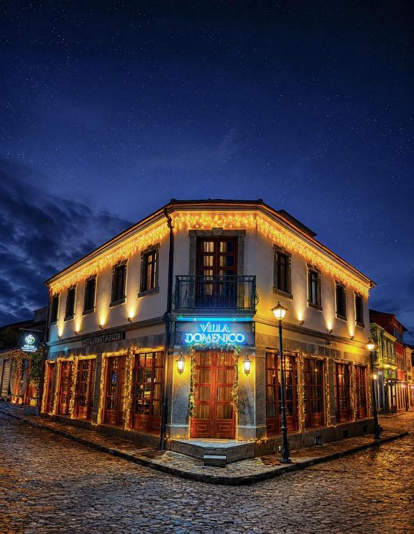 a lit up building on a street at night at Villa Domenico Korce Old Bazaar in Korçë