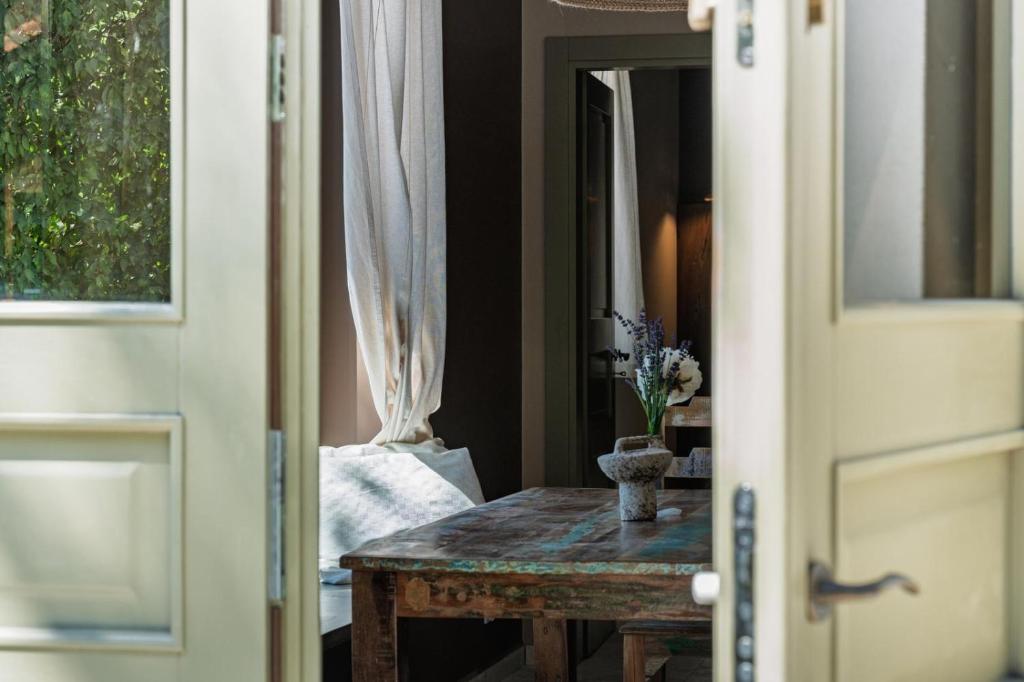 a table with a vase on it next to a door at Domek pod Grabami in Gdańsk