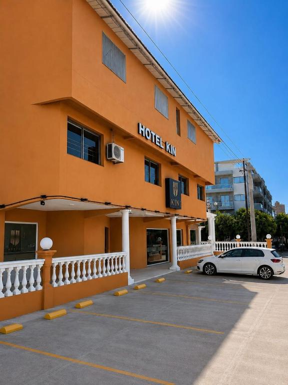 a hotel with a car parked in front of it at KIN Hotel in Villa Carlos Paz
