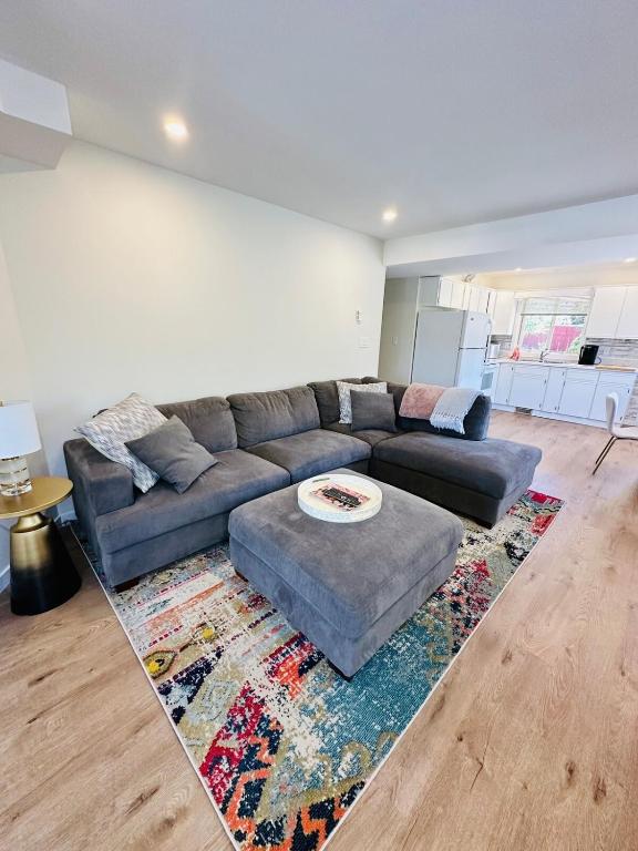 a living room with a couch and a rug at The Wineries are Calling! in Penticton