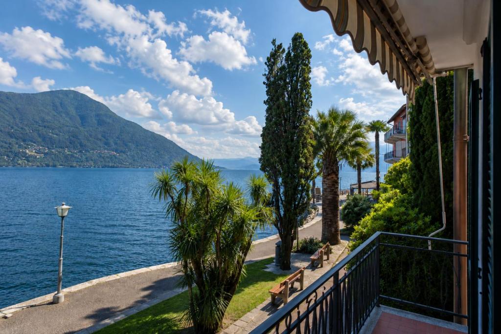 a balcony with a view of the water and mountains at Rivalago - Lake front apartment on Lake Promenade in Brissago