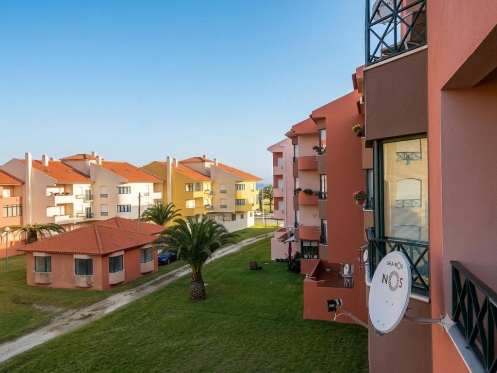 a view of an apartment complex with a palm tree at SwordFish Beach Escape Apartment in Atouguia da Baleia