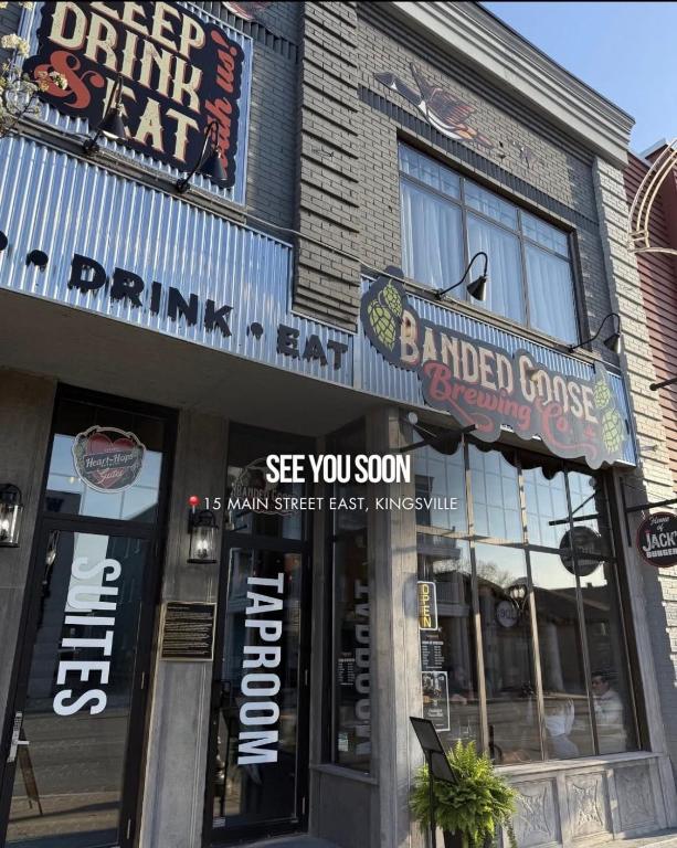 a building with a bunch of signs on it at Heart & Hops Brewery Suites in Kingsville