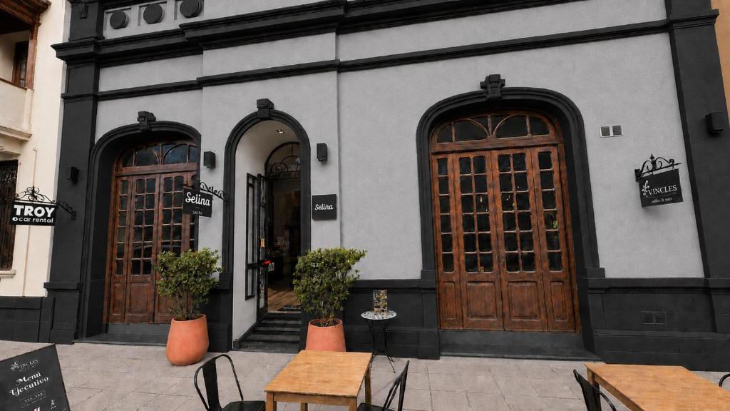 two doors of a building with tables and chairs at Selina Salta in Salta