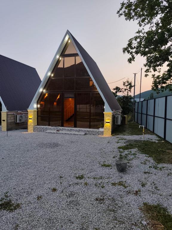 a large wooden building with a gambrel roof at Kungut A-Frame Deluxe in Sheki
