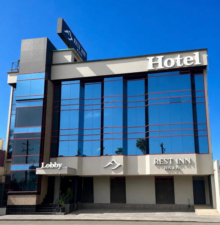 a hotel with a sign on top of a building at Rest Inn Baja in Ensenada