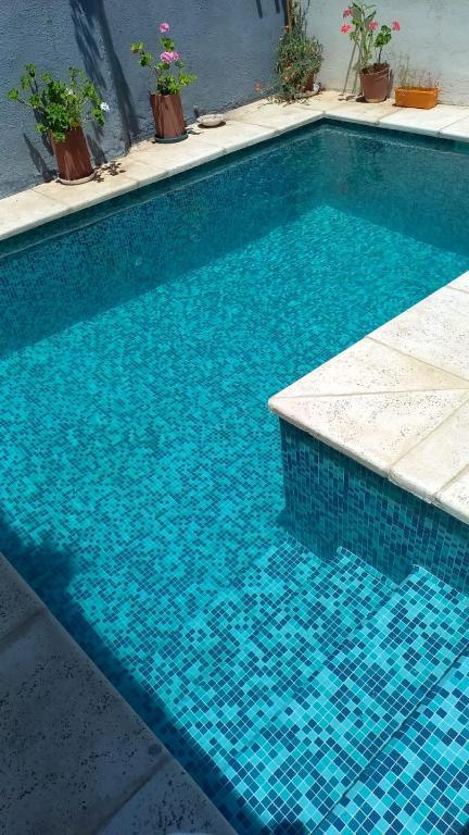 a blue swimming pool with blue tiles on it at Super duplex Martinez in Martínez