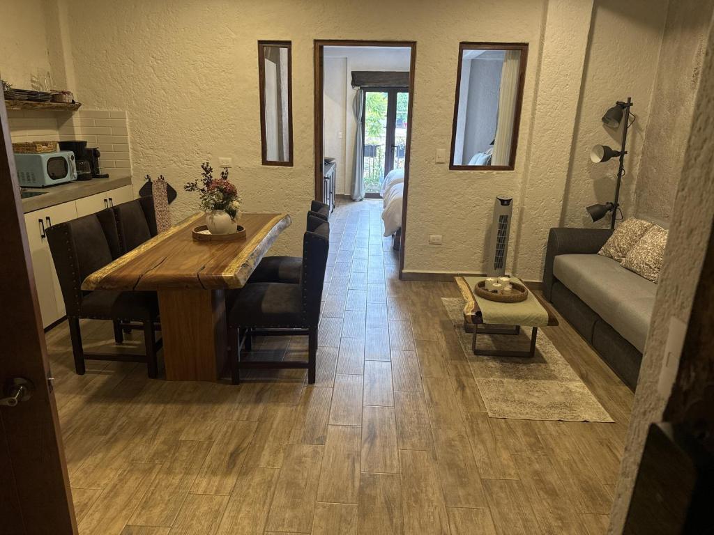 a living room with a table and a living room with a couch at Anae en ValQuirico in Santeagueda