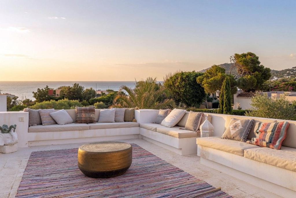 a living room with couches and a coffee table at Sunset Sea View Villa with Private Pool in Sant Josep de sa Talaia