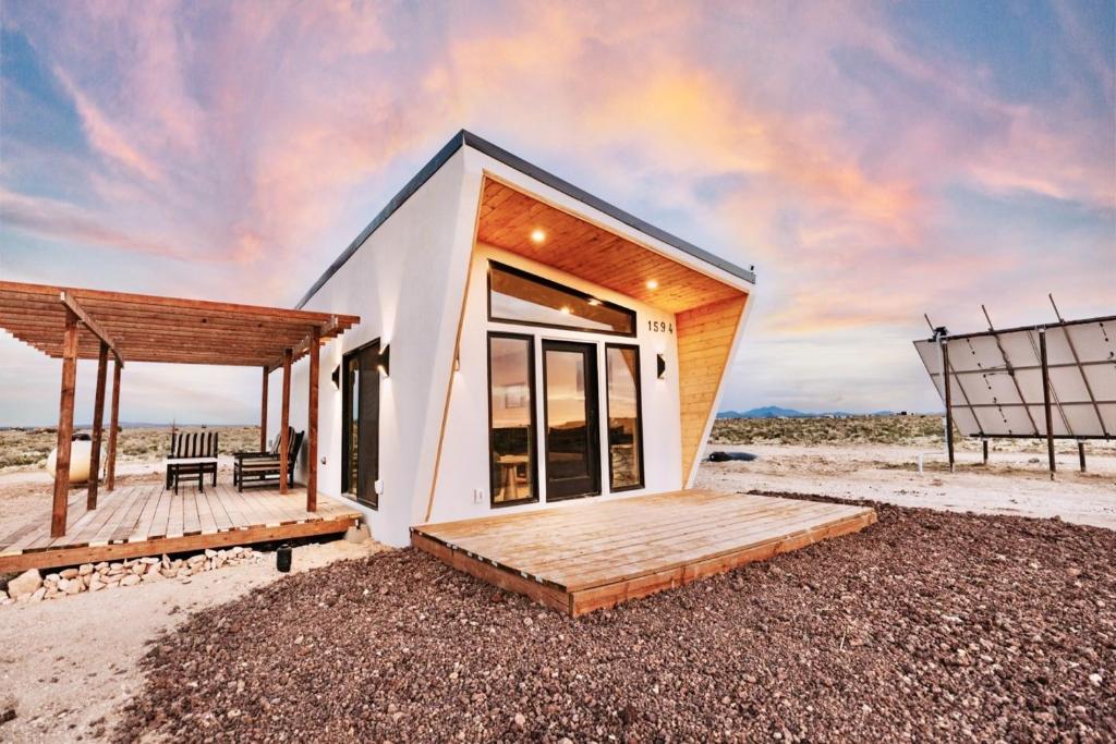 a small house with a deck on the beach at Grand Canyon Stargazing Off-Grid in Williams
