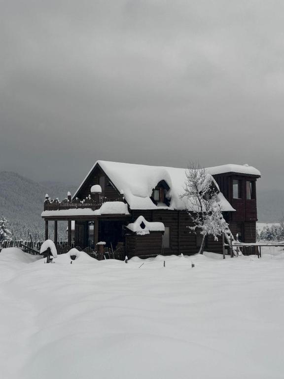 a house with snow on the roof of it at Boravak Tarhaniš Rožaje in Rožaje