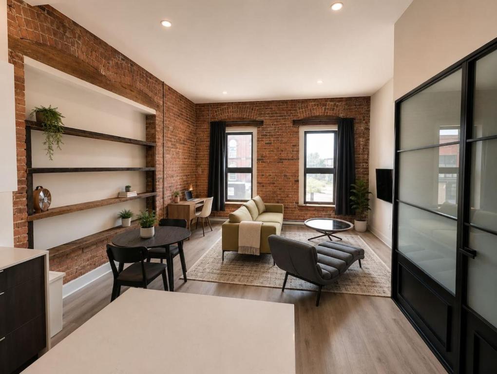 an open living room with a brick wall at The Post Hotel in Renfrew