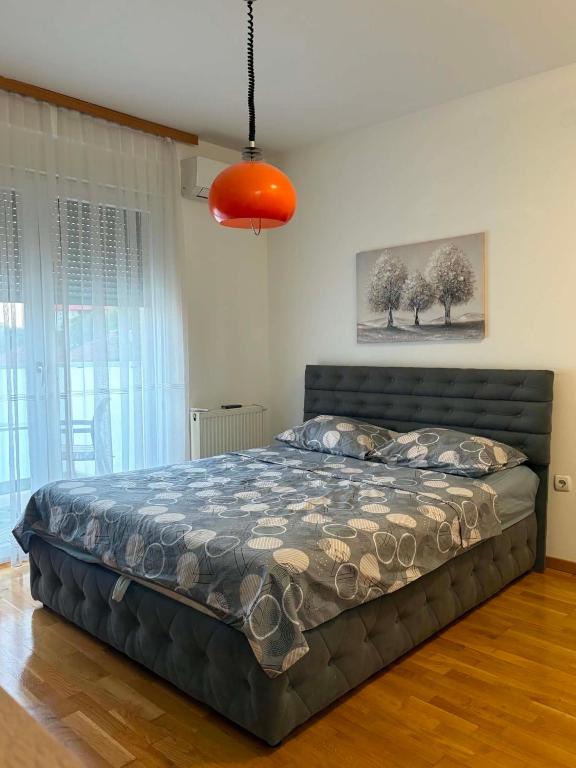 a bedroom with a large bed in a room at Apartman 14 in Doboj