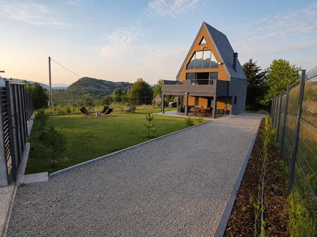a house with a pointed roof with a pathway at Peak Vista A-Frame in Sarajevo