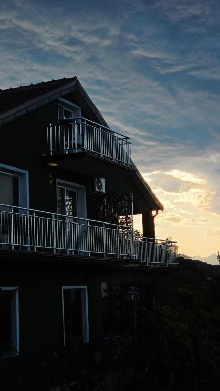 a house with a balcony on the side of it at Pateriku Apartments in Shkodër