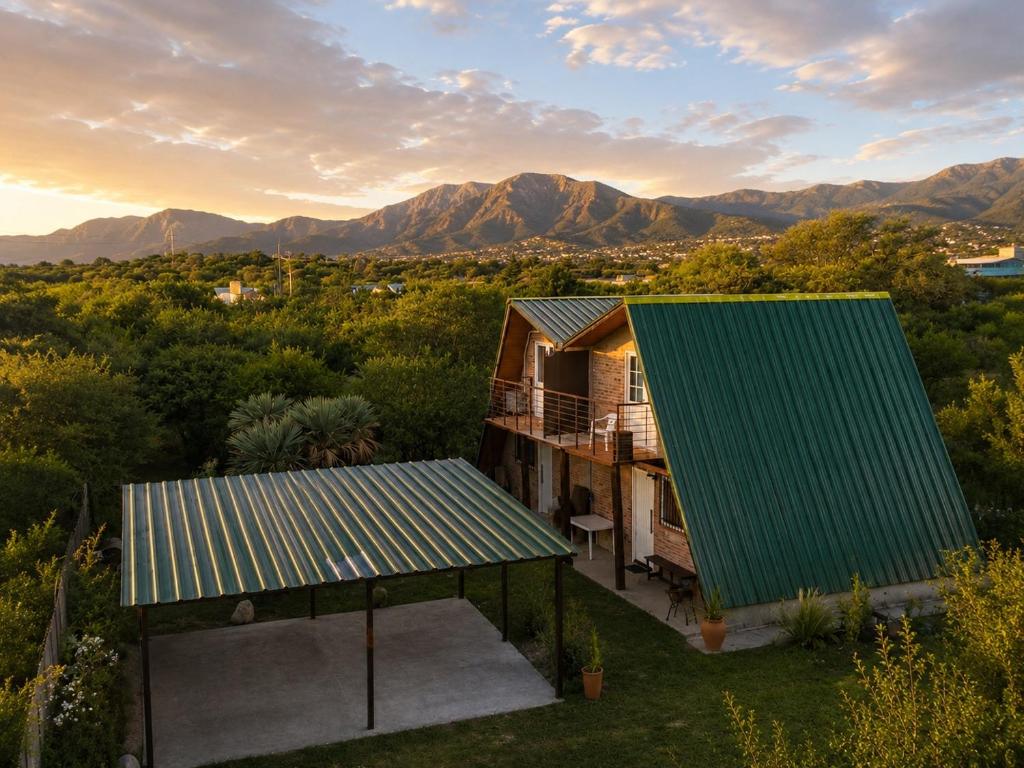 an aerial view of a house with a green roof at Cabañas Caranday in Capilla del Monte