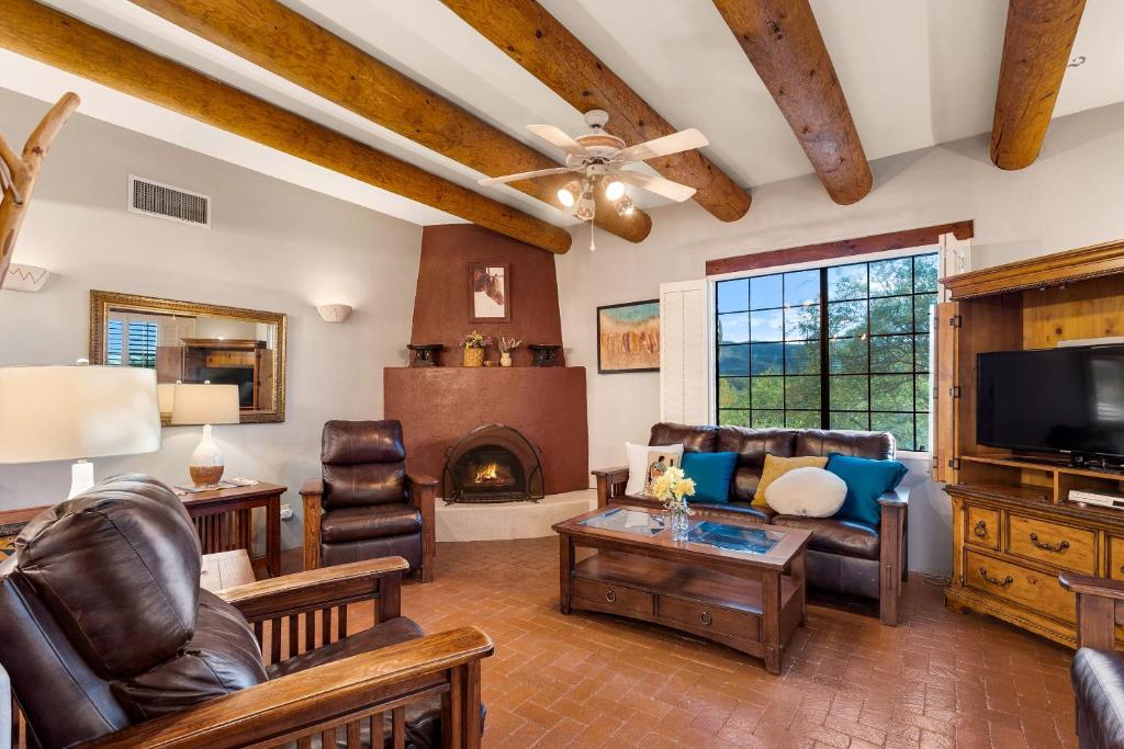 a living room with leather furniture and a fireplace at Cereus Vista in Tucson