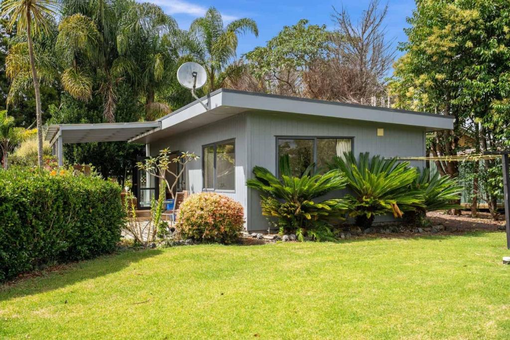 a small house with a antenna on top of it at Pickmere Oasis in Kerikeri