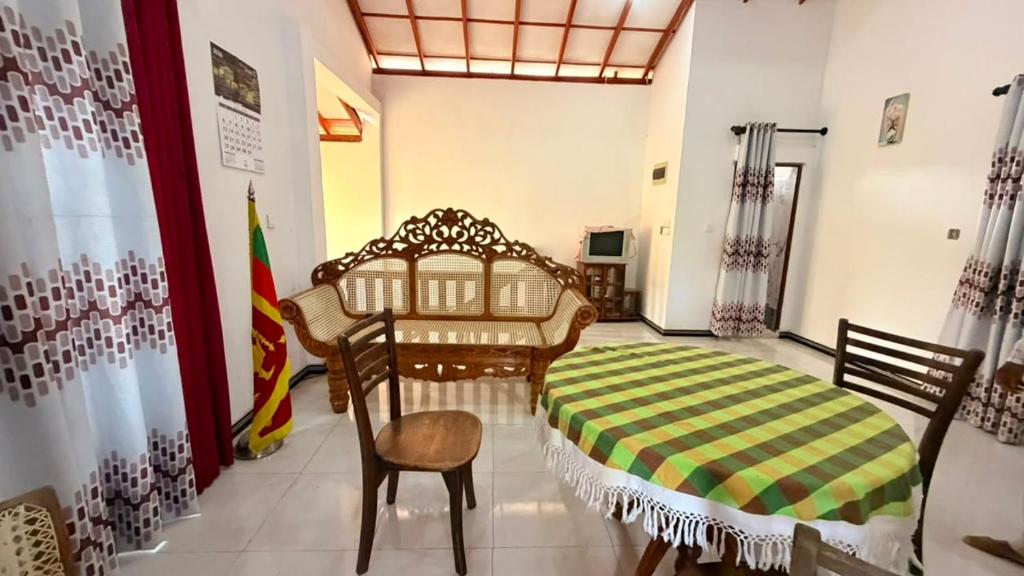 a room with a bed and a chair and a flag at Blissful Chateau in Batigama