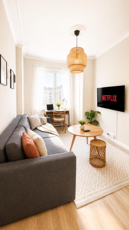 a living room with a couch and a table at GuestFirst- Modern Boho Charm in Kallio Helsinki Center in Helsinki