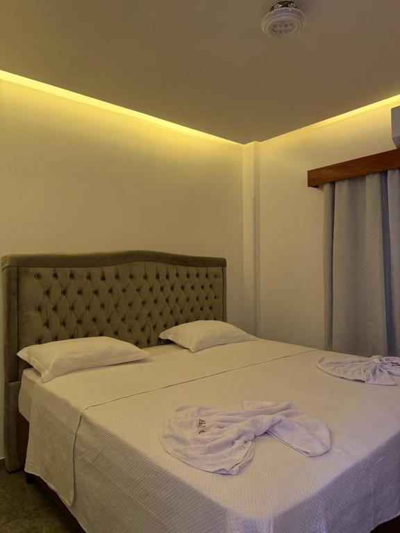 a bedroom with a bed with two towels on it at Hotel Omega in Oiapoque