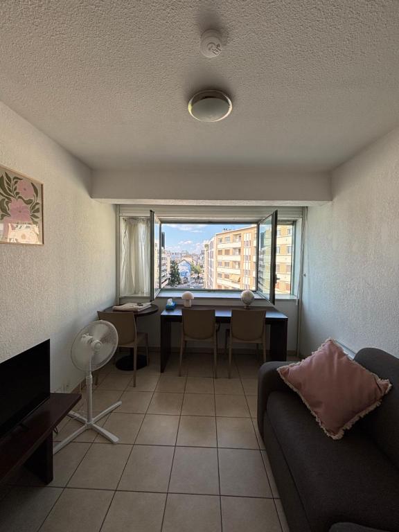 a living room with a table and a couch at L'escapade in Annemasse