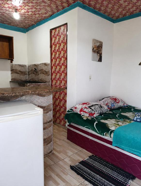 a room with a bed and a fireplace in it at Vila Sol & Mar Gaibu PE in Cabo de Santo Agostinho