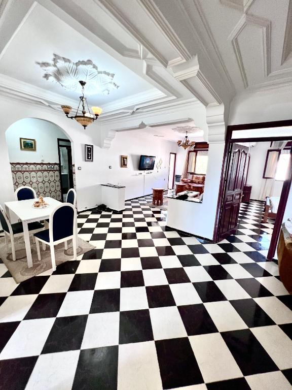 a room with a black and white checkered floor at Blue Pearl city in Chefchaouen