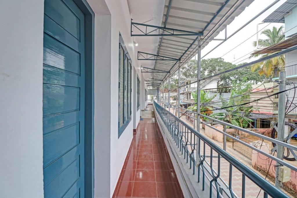 a corridor of a building with a blue door at Hotel O Skywind in Trivandrum