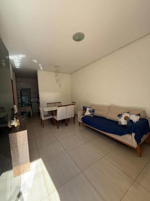 a living room with a couch and a table at Sobrado Flamboyant in Goiânia