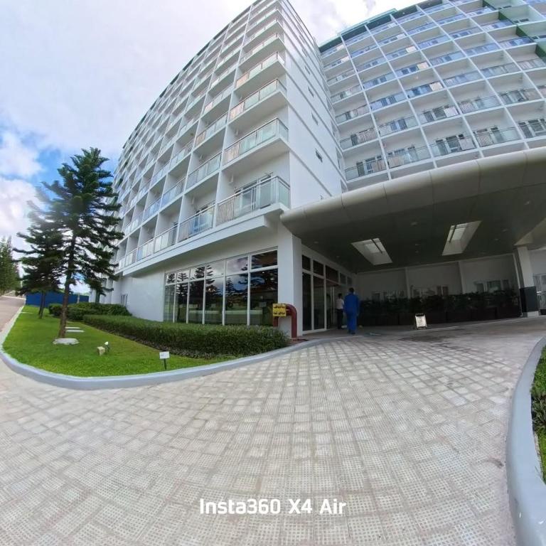 a building with a person standing in front of it at Condo Unit at Cool Suites SMDC Wind Tagaytay in Tagaytay