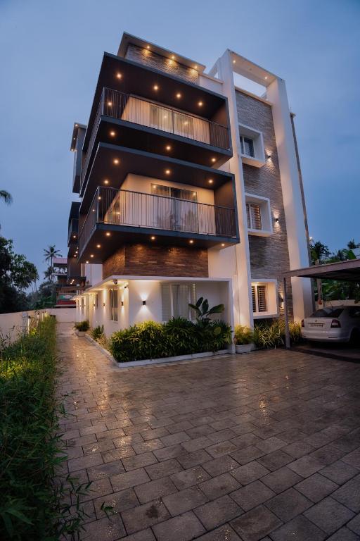 a large building with lights on the side of it at Rivera Residency , Kazhakuttom in Murukkumpuzha