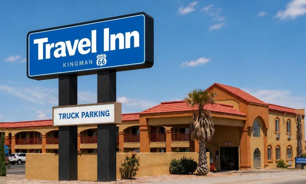 a sign for a hotel in front of a building at Travel Inn Kingman Route 66 in Kingman