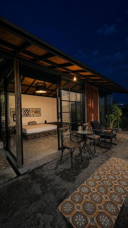 a pavilion with a bed and a bench and a table at El Caney Experiences in Armenia