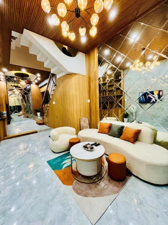 a living room with a couch and a table at Ruby Home Quy Nhon in Quy Nhon