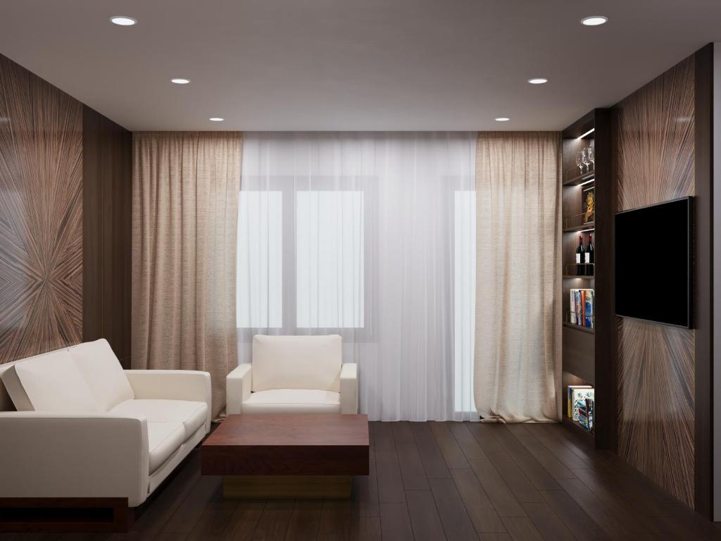 a living room with a white couch and a window at Reviah Hotel in Hanoi