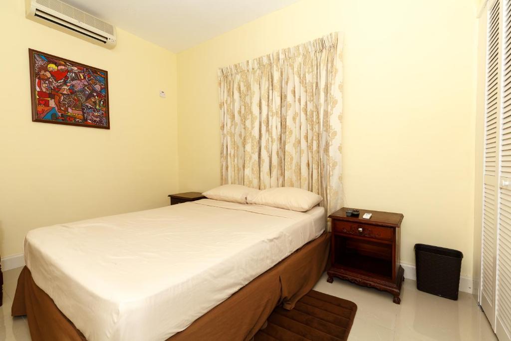 Postel nebo postele na pokoji v ubytování Jasmine Inn