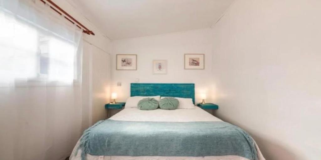 a bedroom with a bed with two pillows on it at Hostal Casa Trancura in Pucón