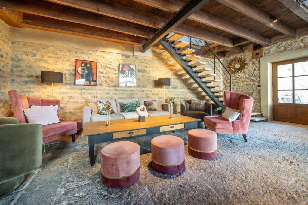 a living room with a couch and a table and chairs at Le Chai des Écluses 4-étoiles gîtes in Saint-Léger-sur-Dheune