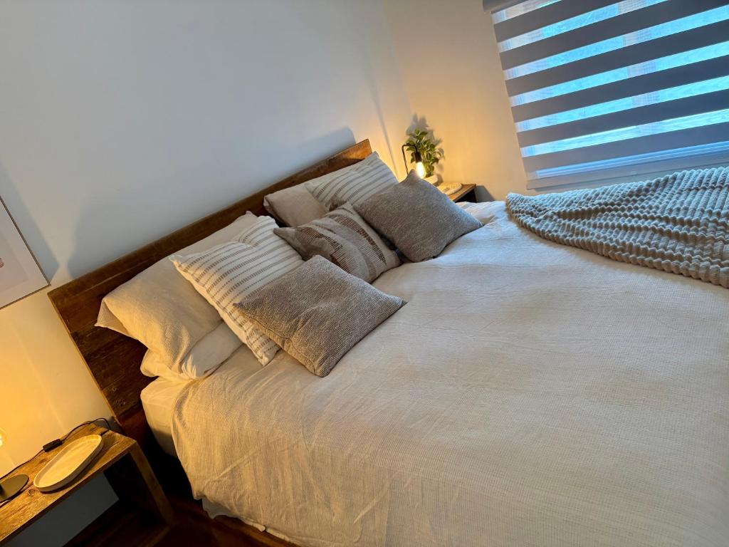 a bedroom with a large bed with pillows on it at La Pergola-1 in Quebec City