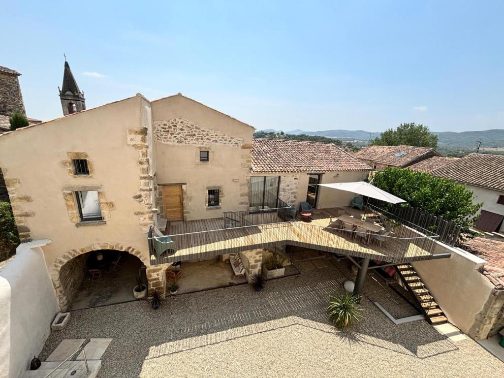 an external view of a building with a patio at Maison éla in Bessas