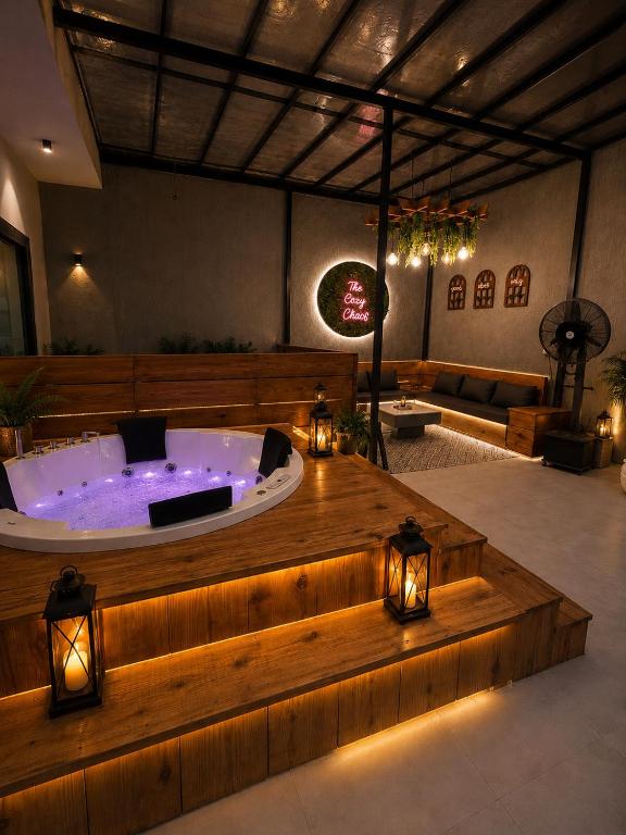 a jacuzzi tub in a large room with lights at The Cozy Chaos - Spa Jacuzzi -Private Terrace - Taj Mahal in Agra